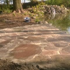 Flagstones (rode Weser zandsteen) als terras  - Hoveniersbedrijf C.K. van Mourik